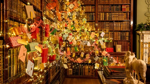 Net lights covered in parcels and letters attached to the bookcases in the Library at Hughenden
